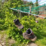 Boots hanging on a washing line to dry after RambAle 18 in May 2022
